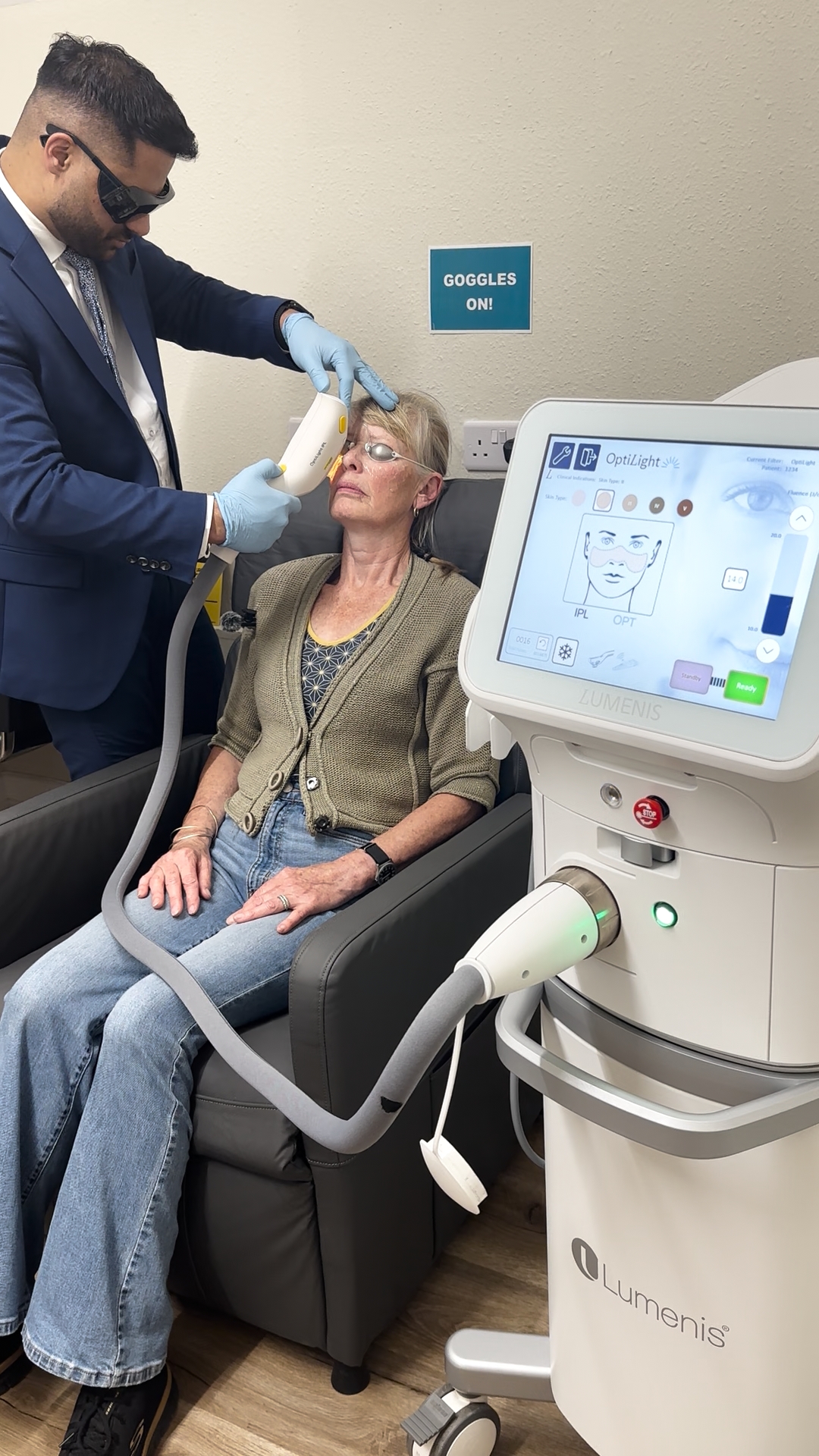 Opticare optometrist delivering a Lumenis OptiLIGHT IPL session to a patient wearing protective goggles
