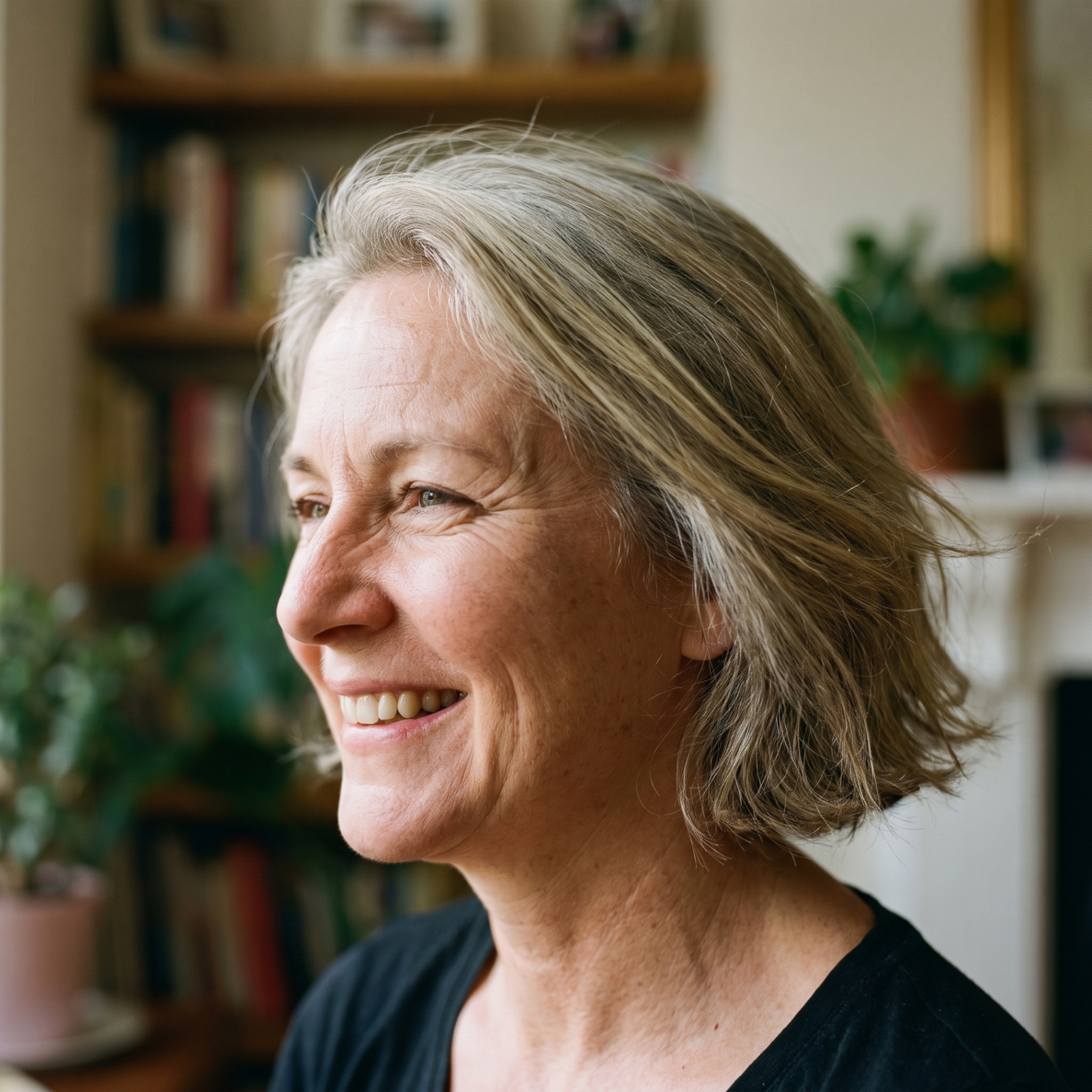 Smiling mature woman in profile, comfortable and clear-eyed after dry eye therapy